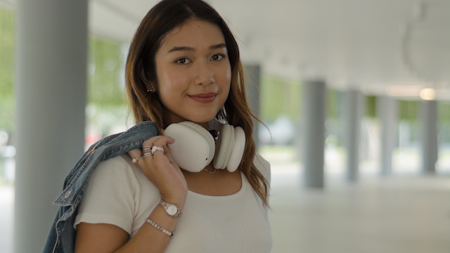 Girl holding onto headphones