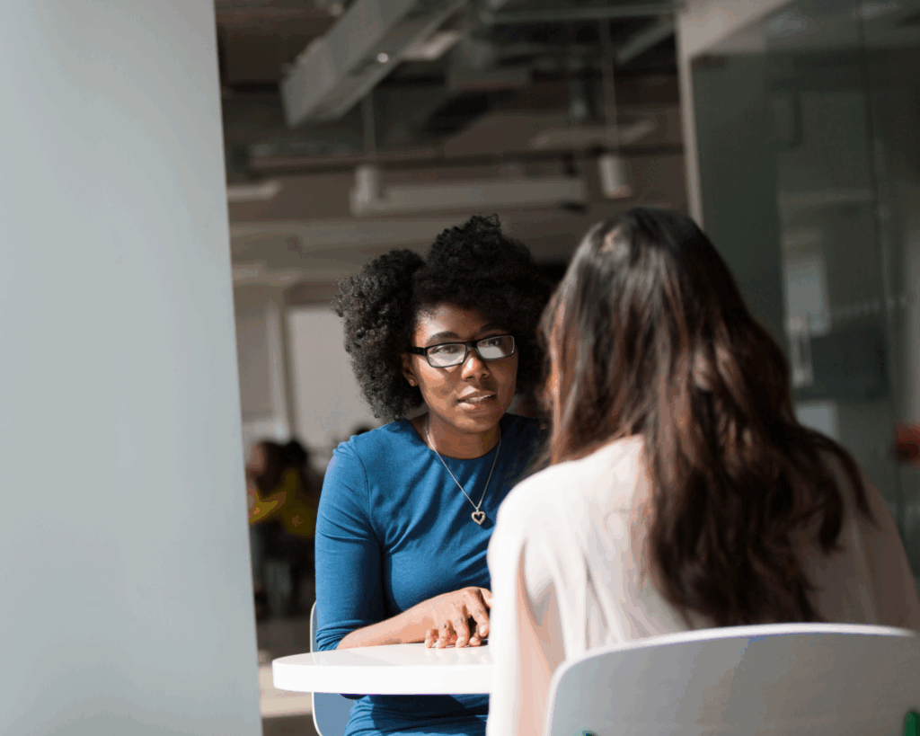 Two women at a table having a discussion